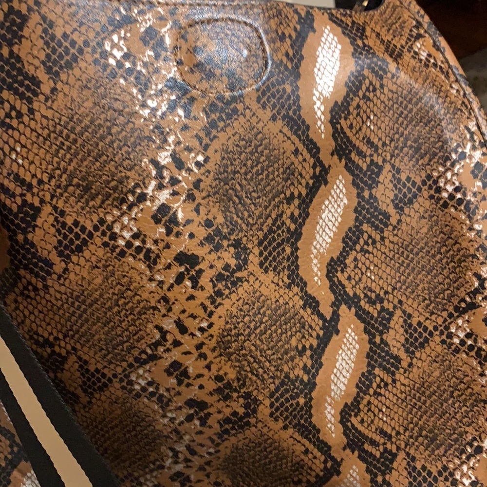 Ah-dorned cross body brown, black and silver bag. Gold hardware on strap